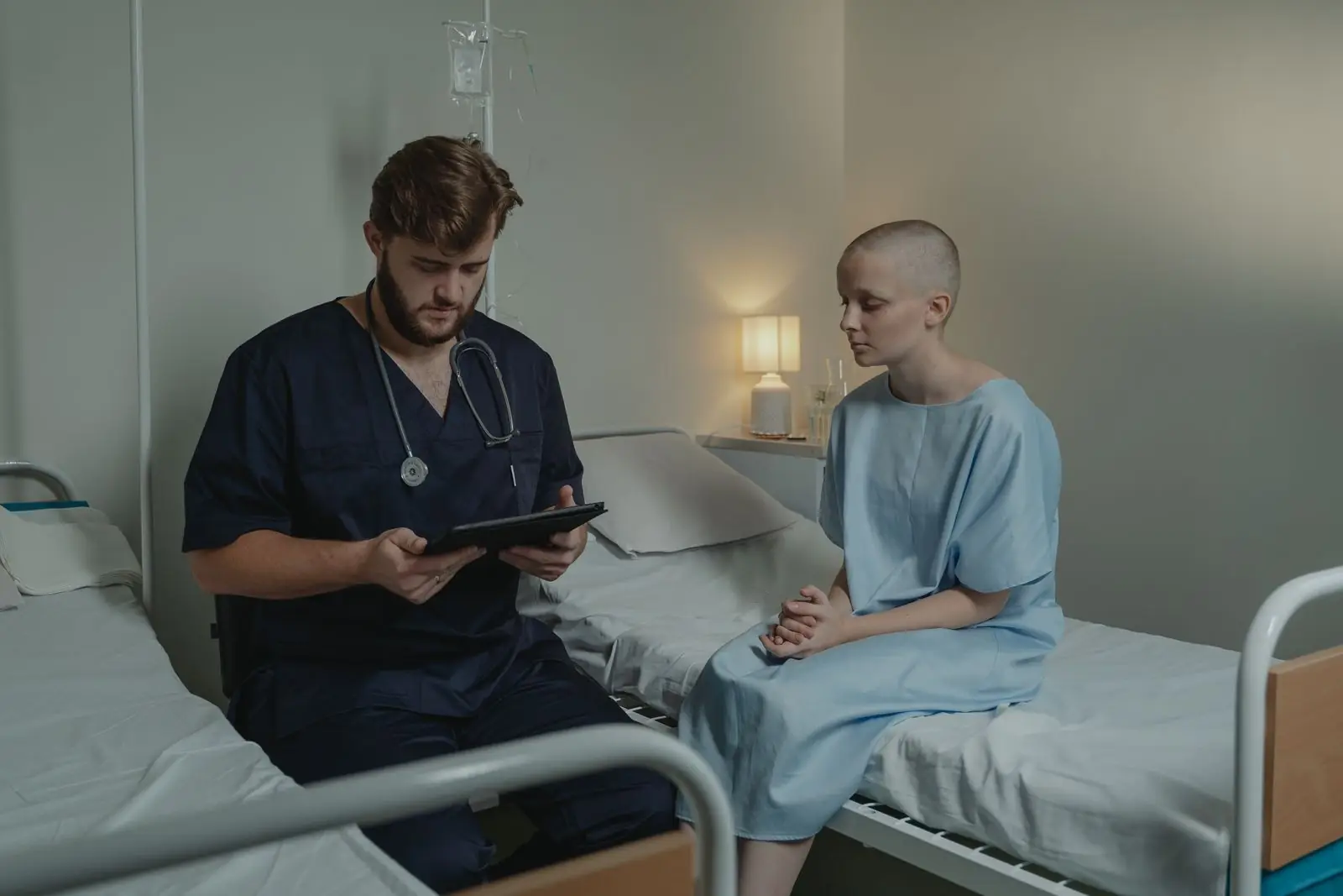Physician consulting a patient in a hospital room