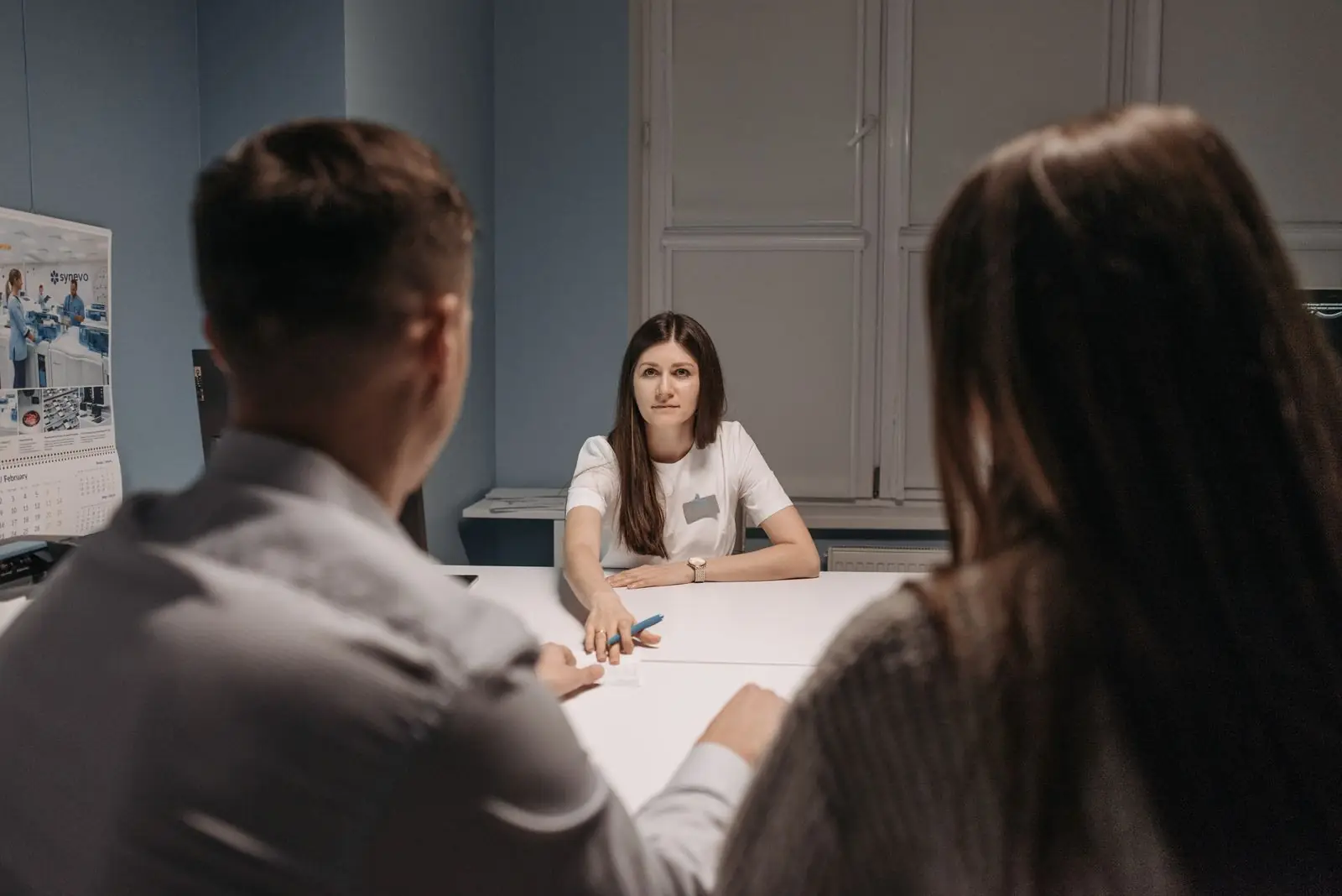Practice leaders meeting around a table in a healthcare office