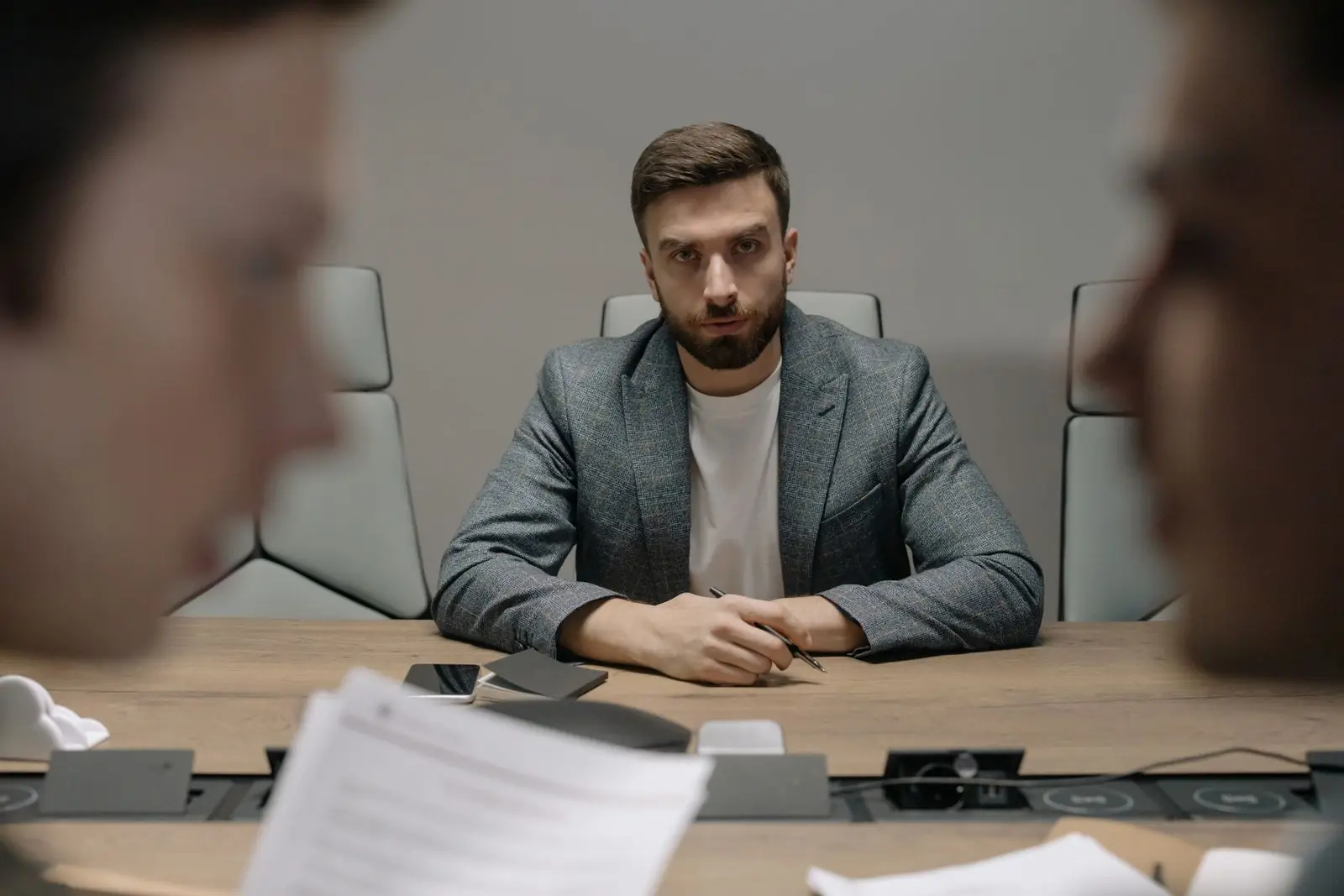 Businessmen in a formal meeting around a conference table